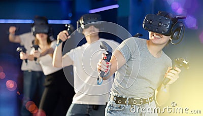 Excited girl in business suit having fun with friends in virtual reality room Stock Photo