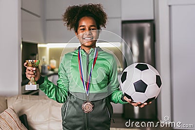 Girl with medals and trophy cup Stock Photo