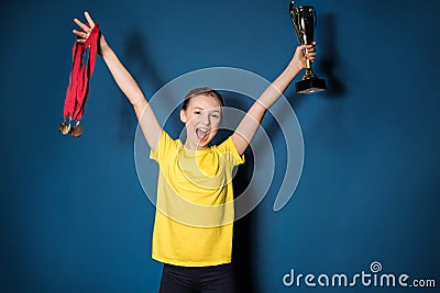 Excited girl with medals and trophy cup Stock Photo