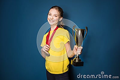 Excited girl with medals and trophy cup Stock Photo