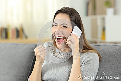 Excited girl receiving good news during a phone call Stock Photo