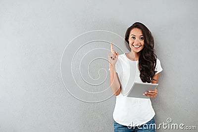 Excited happy asian woman holding tablet computer Stock Photo