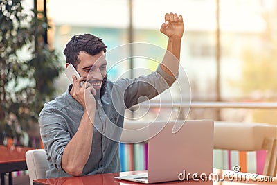 Excited happy bearded freelancer reading email with results about victory in modern online contest sitting at laptop Stock Photo