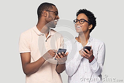 Excited black family spouse received sms with sale price. Stock Photo