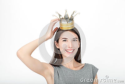 Excited happy looking woman wearing a handmade princess crown. Closeup of happy mixed race asian caucasian female model isolated o Stock Photo