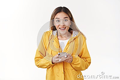 Excited joyful charismatic young modern asian blond girl fascianted awesome new smartphone game cannot stop playing app Stock Photo