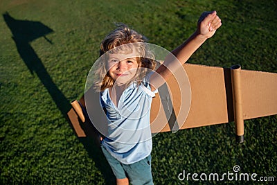 Excited kid superhero with jetpack. Child pilot play on summer day. Success, leader and winner concept. Imagination and Stock Photo