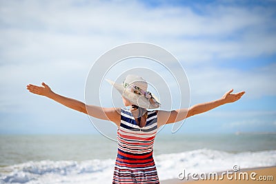 Excited lady in hat spreading hands with joy Stock Photo
