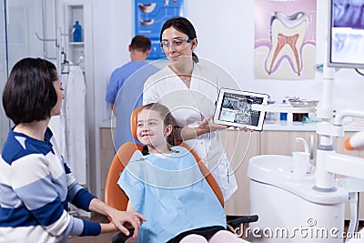 Excited little girl in dentist cabinet for periodic check up Stock Photo