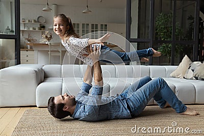 Excited little girl and happy daddy playing airplane Stock Photo
