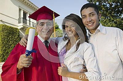 Excited Male Graduate With Family Stock Photo