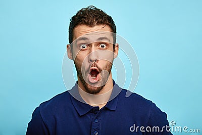 Excited man expresses amazement, looks at the camera. Stock Photo