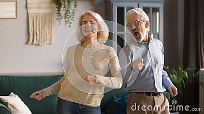 Excited mature couple, man and woman having fun, dancing together Stock Photo