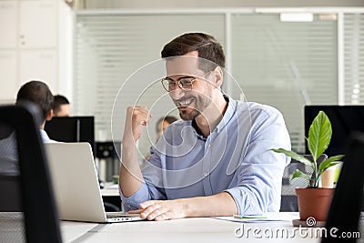 Excited motivated worker happy by receiving good news in email Stock Photo