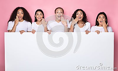 Excited Multiethnic Ladies Holding Poster With Copy Space, Pink Background Stock Photo