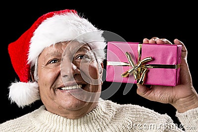 Excited Old Man With Santa Cap And Magenta Gift Stock Photo