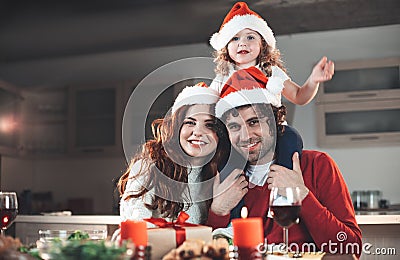 Excited parents celebrating New Year with lovely daughter Stock Photo