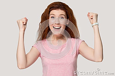 Excited redhead girl feel euphoric about success Stock Photo