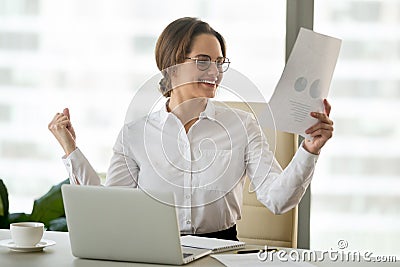 Excited businesswoman happy with good work results in financial Stock Photo