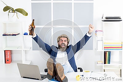 Excited satisfied happy employee with alcohol after meeting or deadline finished work day in time on friday. Stock Photo