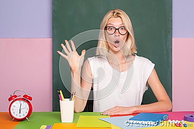 Excited school teacher in class on blackboard background. Professional portrait. Stock Photo