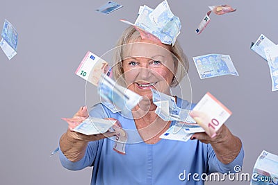 Excited senior lady celebrating a windfall Stock Photo