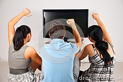 Excited soccer fans watching tv Stock Photo