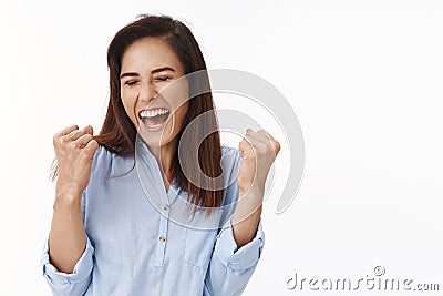 Excited successful ambitious middle-aged brunette woman in office blue blouse winning bet, fist pump celebration gesture Stock Photo