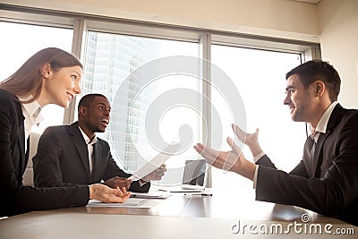 Excited surprised multi-ethnic recruiters listening to businessm Stock Photo