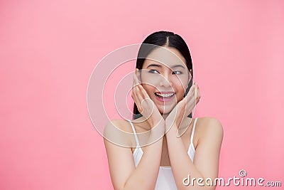 Excited and surprised smiling Asian 20s woman isolated over pink background. Stock Photo