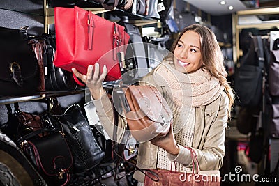 Excited woman customer purchasing new hand bag Stock Photo