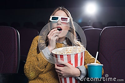 excited woman in 3d glasses eating popcorn and watching movie Stock Photo