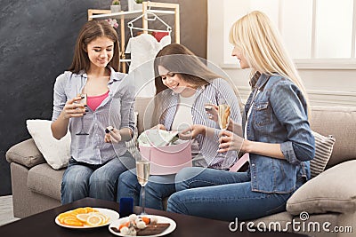 Excited woman getting gift from her friends Stock Photo