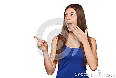 Excited woman showing finger on copy space for product or text, isolated over white background Stock Photo