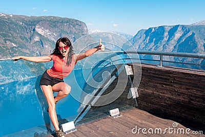 Excited woman tourist at Stegastein Viewpoint Stock Photo