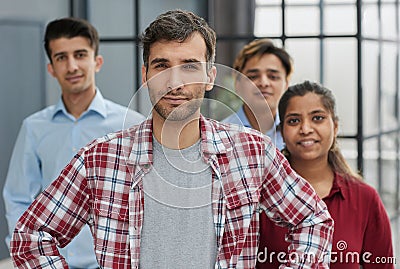 A group of business workers look seriously and confidently at the camera. Stock Photo