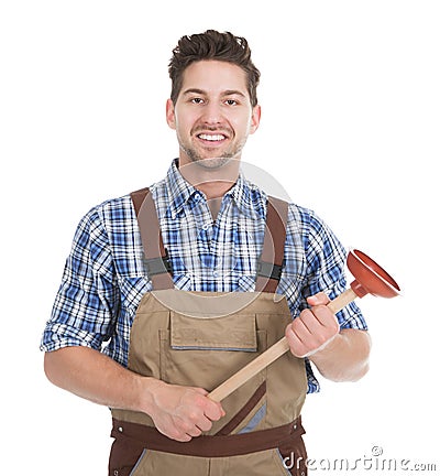 Excited Young Male Plumber Holding Plunger Stock Photo