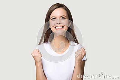 Excited young woman clench fists as sign of victory Stock Photo