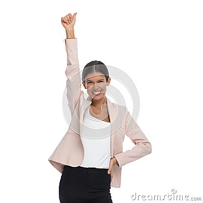 Excited young woman holding hand up and making thumbs up gesture Stock Photo