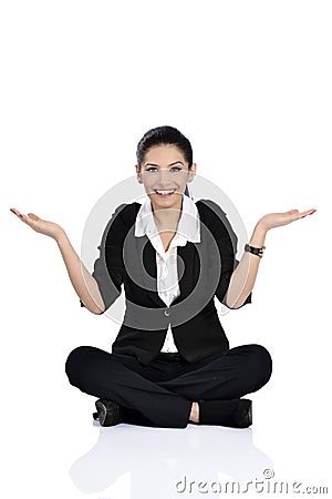 Excited young woman sitting on ground Stock Photo