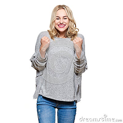 Excitement and amazement. Attractive young woman clenching fists, screaming with joy. Unbelievable surprise, success or winning. Stock Photo