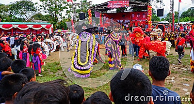 The excitement of the lumping horse and lion dance art performances, at the Gelora Field, Muntok City Editorial Stock Photo