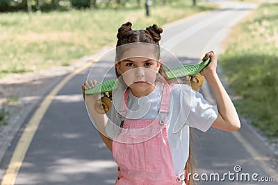 An exciting hobby is skateboarding. Girl and skateboard. Sports lifestyle. Stock Photo