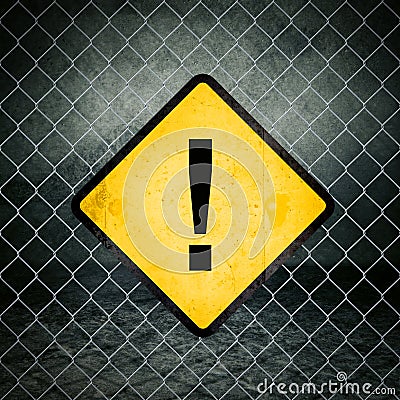 Exclamation Mark Grunge Yellow Warning Sign on Chainlink Fence Stock Photo