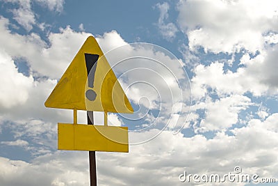 Exclamation point of attention on a yellow triangular sign with a sign for signing. Stock Photo