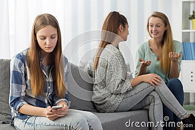 Excluded teenager looking at smartphone Stock Photo