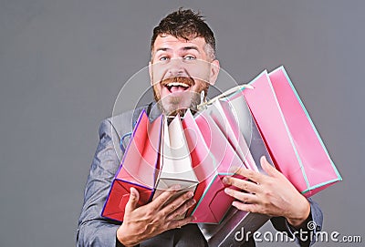 Exclusive commercial offer. Man bearded businessman customer carry many shopping bags. Enjoy shopping profitable deals Stock Photo