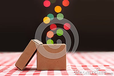 Exclusive gift box on red scotch pattern with light bokeh Stock Photo