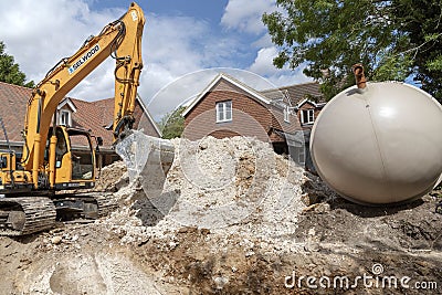 Excuvating chalk to form a trench for a plastic tank Editorial Stock Photo