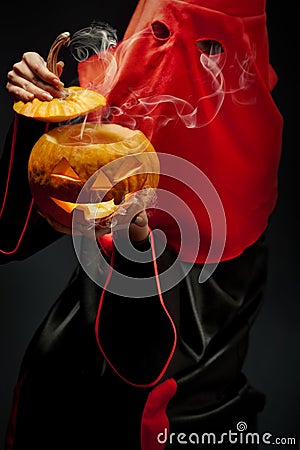 Executioner with halloween pumpkin Stock Photo